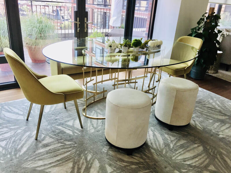 This 60% wool/40% silk hand-knotted Nepalese rug from Stark Carpet sits perfectly under this Safavieh Couture dining table (with hide stools by Arteriors Home and dining chairs from West Elm Chelsea)