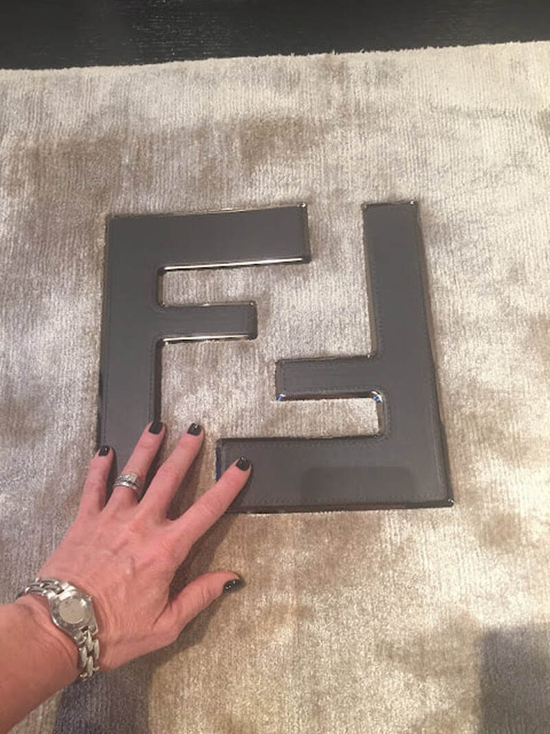 Fendi incorporated their logo as metallic insets into their silk rugs at their NYC showroom 